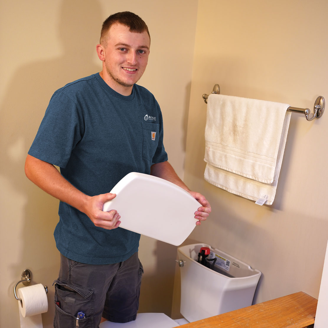 Plumber fixing a toilet