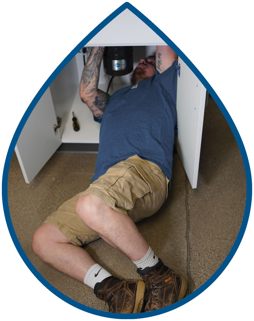 Plumber under a sink Plumber under a sink