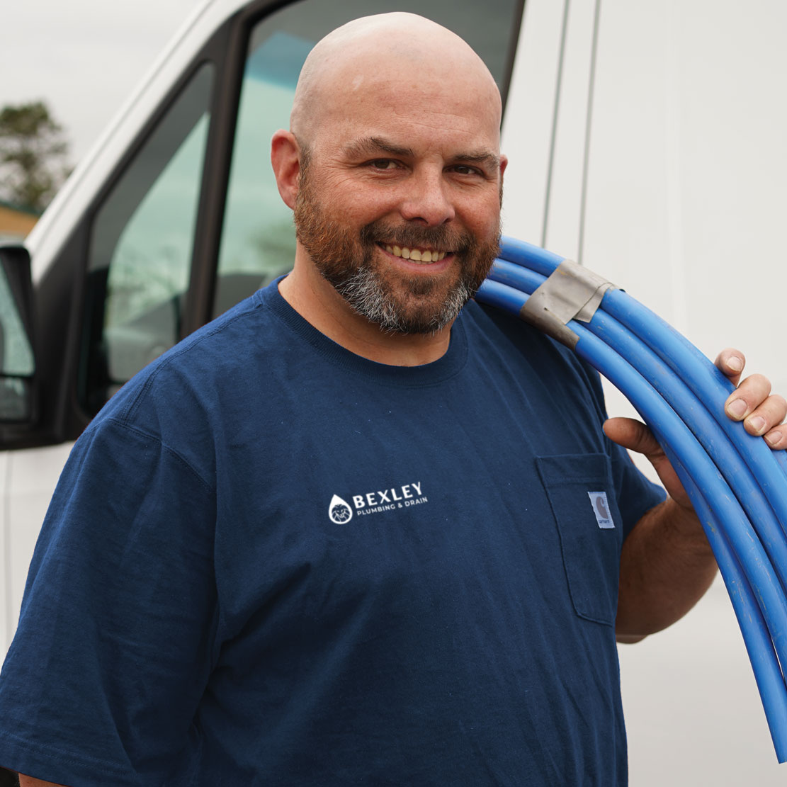 Plumber Holding Sewer Lines